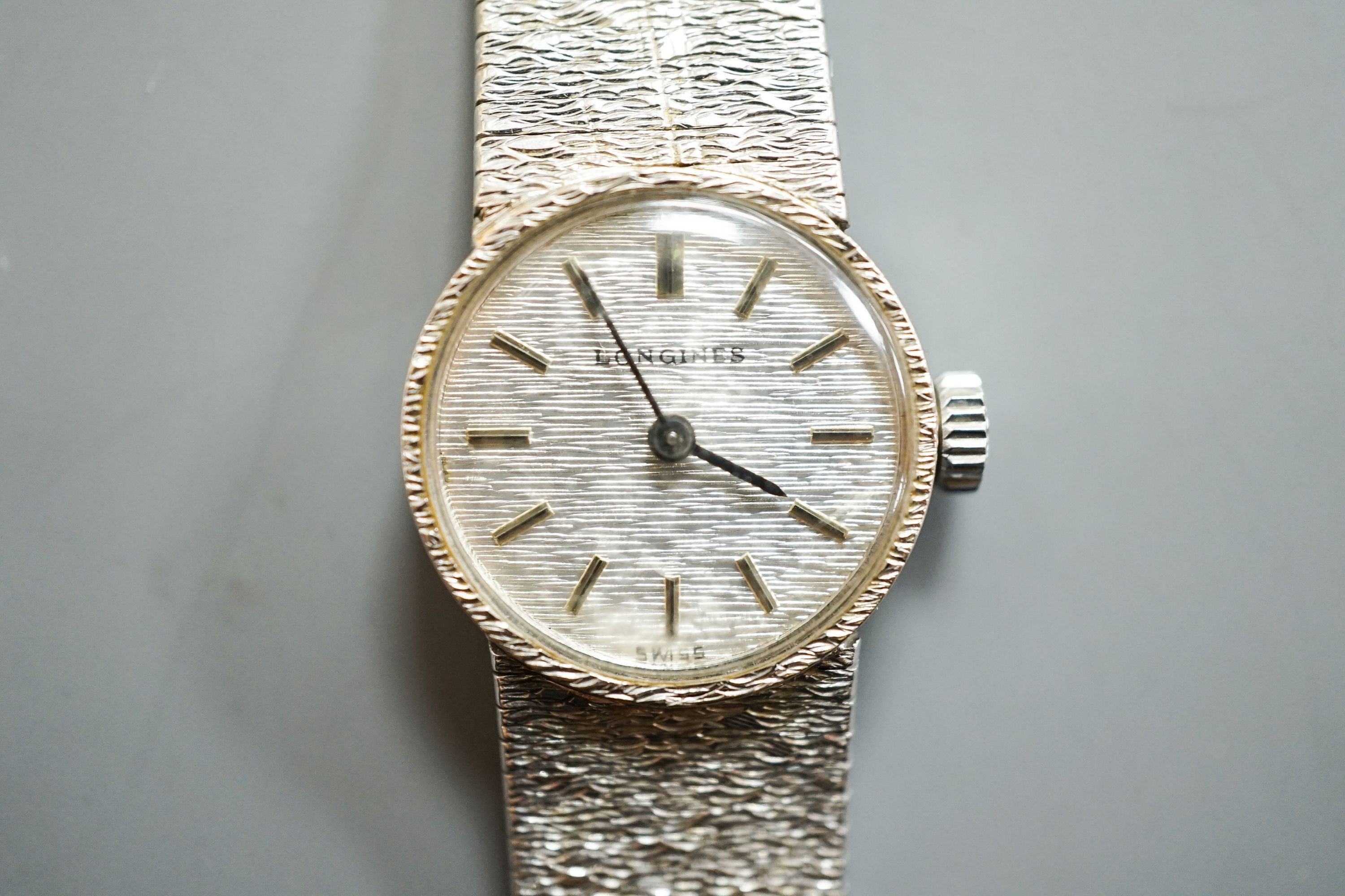 A lady's textured 9ct white gold Longines manual wind wrist watch, case diameter 19mm, overall length 15.2cm